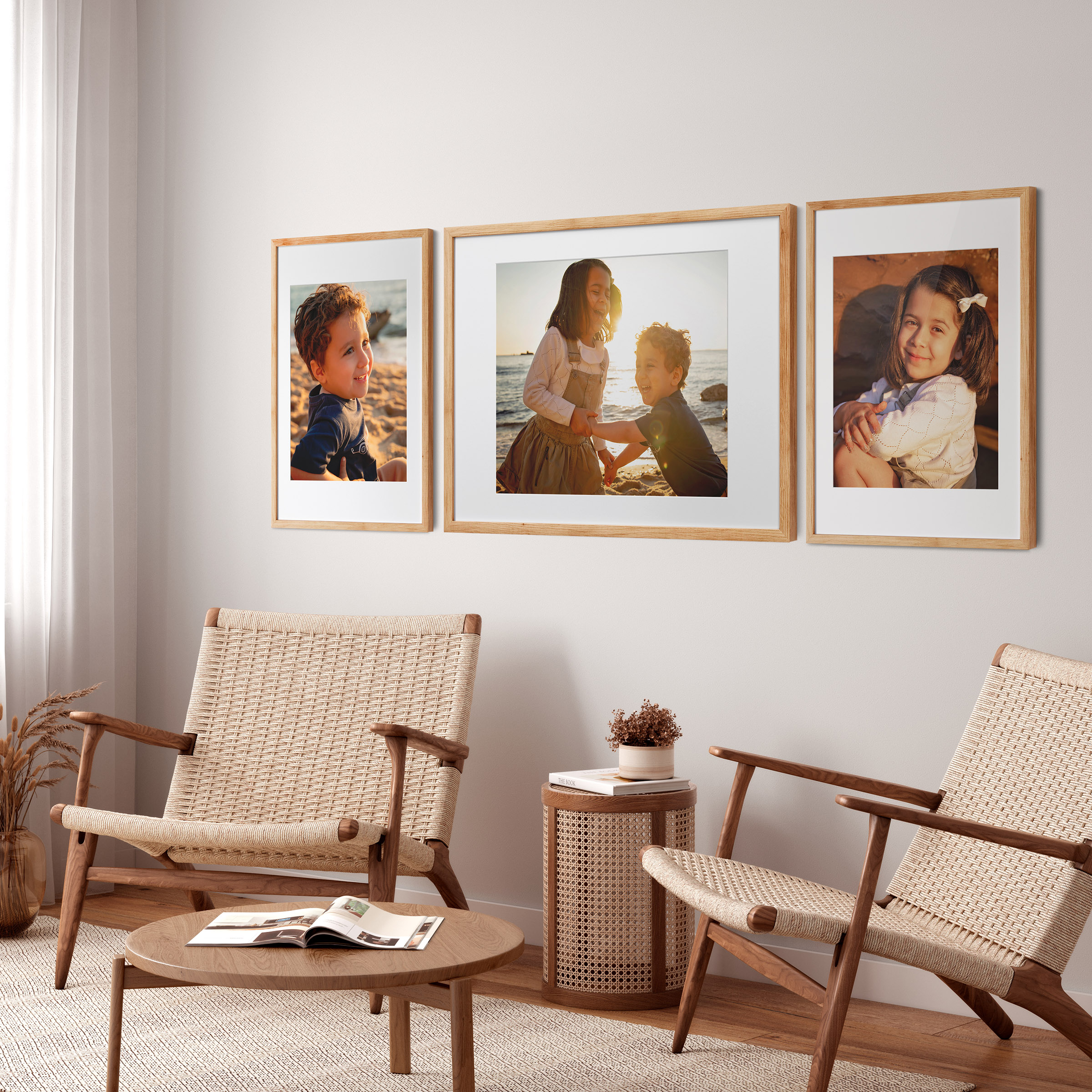 Oak framed portrait prints displayed above lounge chairs in a contemporary living room