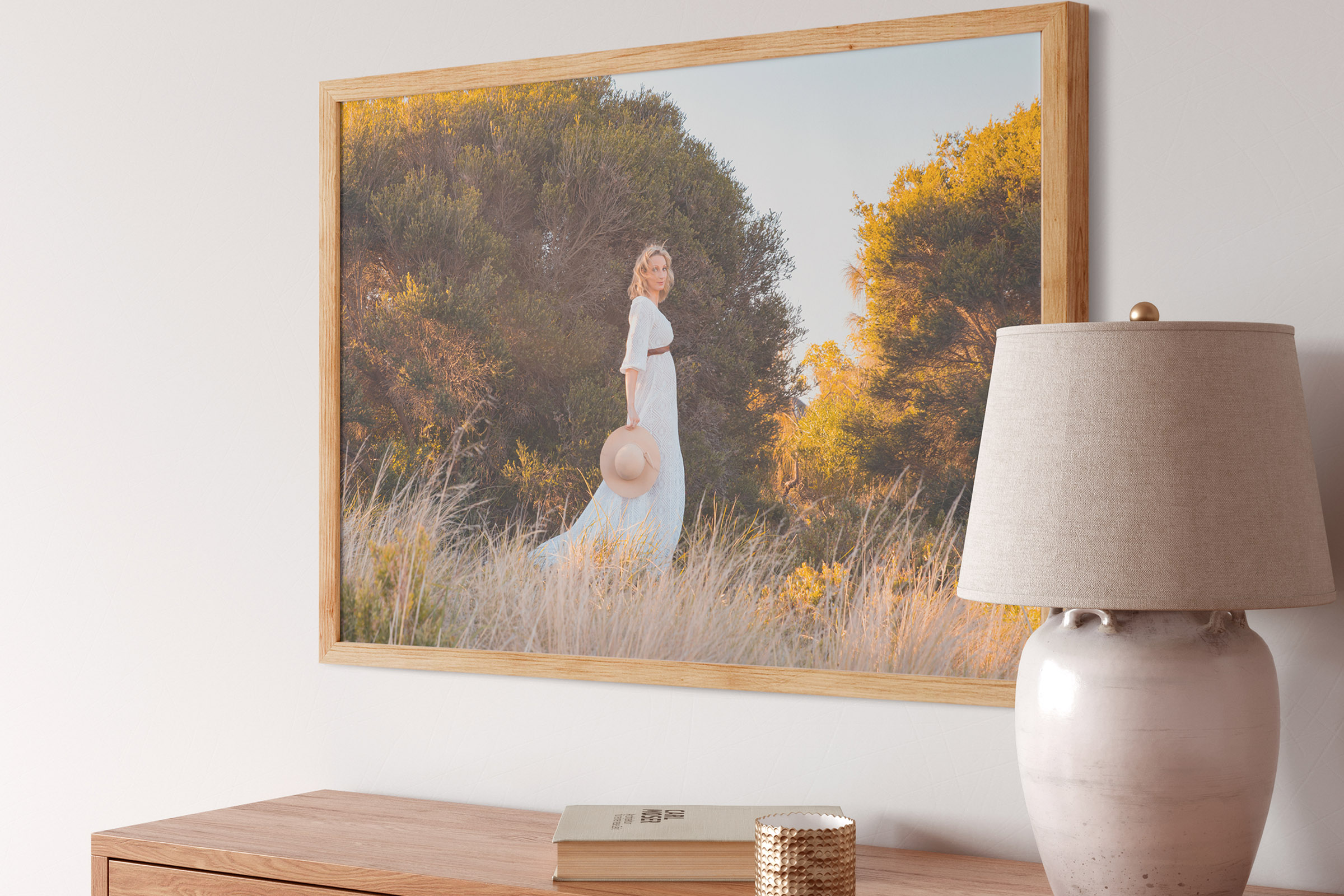 Oak framed portrait artwork displayed above a console in a contemporary home