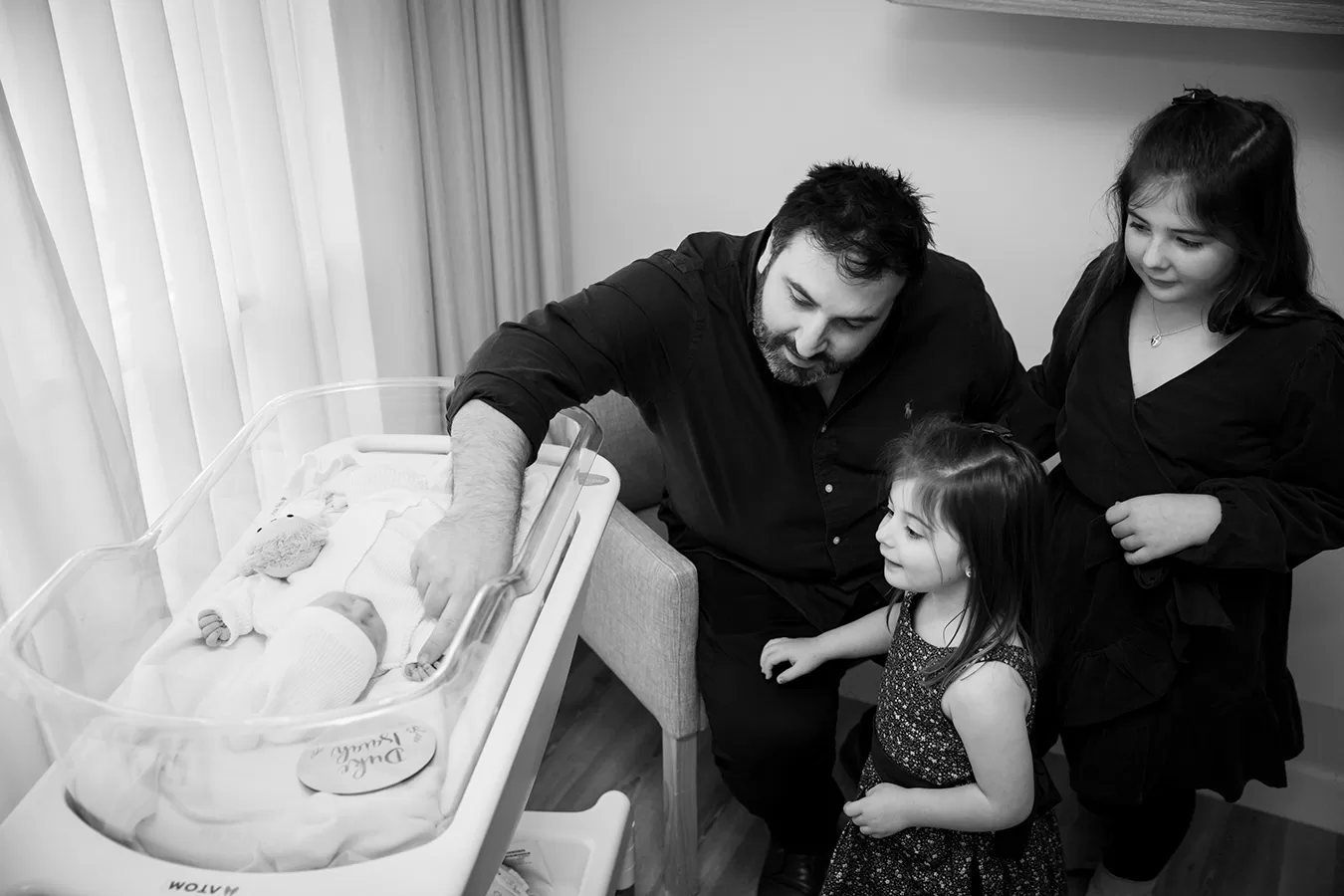 Black and white birth portrait — strength and connection during labour