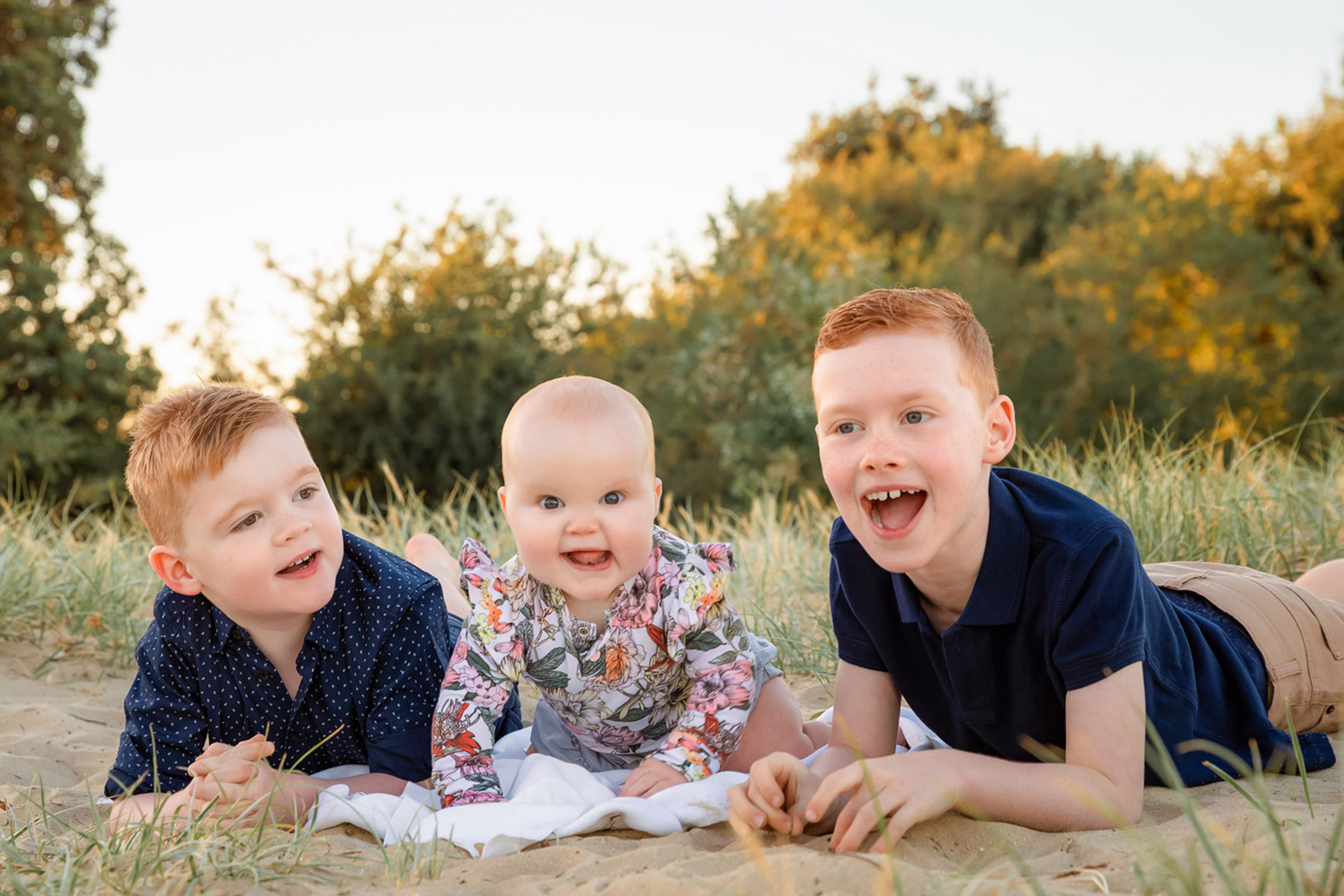 Siblings portrait at the beach during sunrise