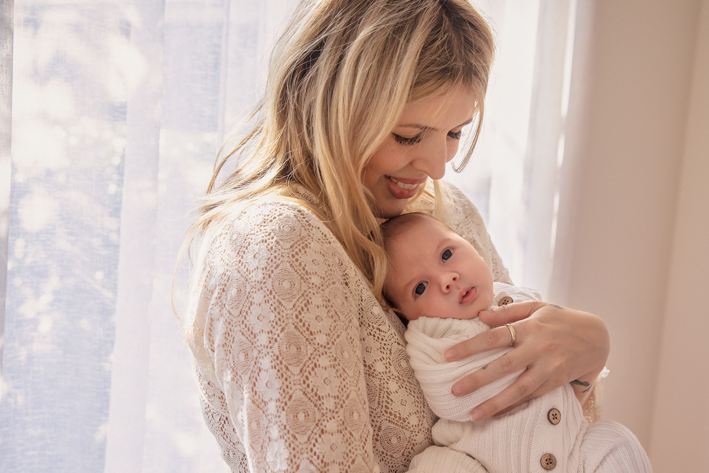 Mother holding her newborn baby during a portrait session