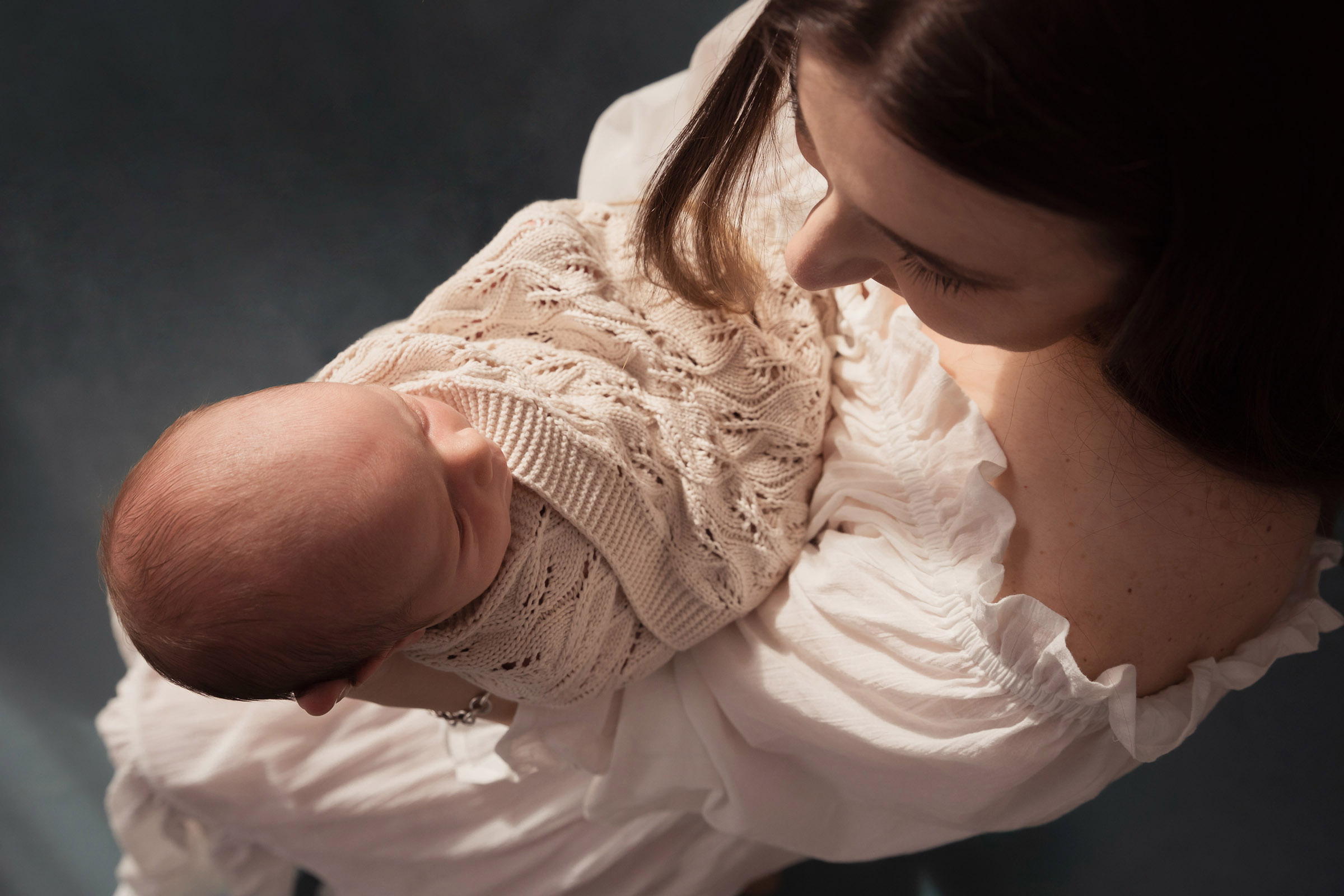 Mother and newborn baby portrait in soft studio light